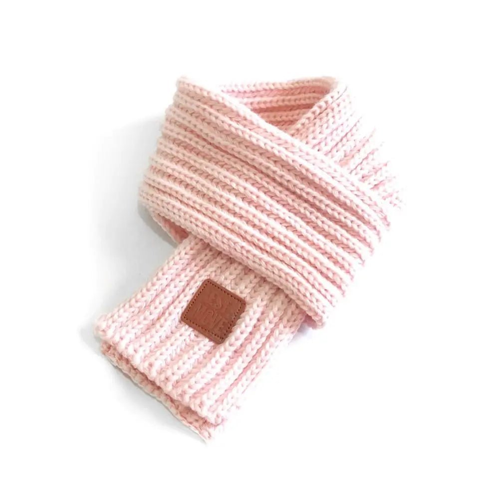 Pink knit pet scarf from Pet Panache Boutique, cozy accessory for small dogs or cats, featuring soft, warm pink yarn.
