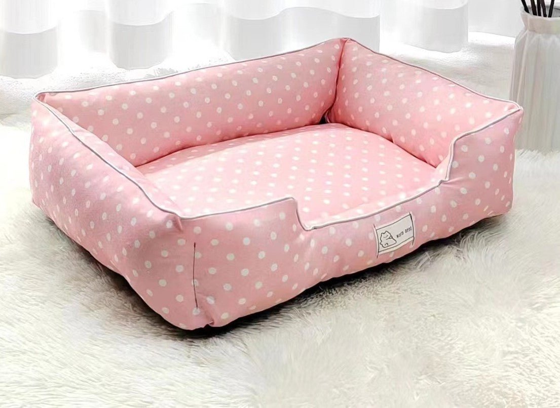 Pink polka dot pet bed from Pet Panache Boutique with soft cushioning, perfect for small to medium pets.