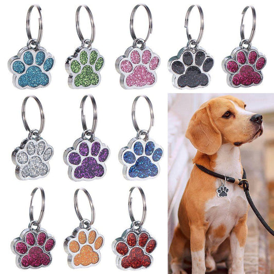 Colorful glitter paw print collar charms for pets with metal rings and a dog wearing a black collar with a glitter paw print charm