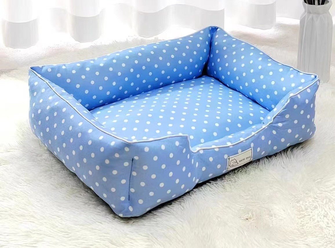 Blue polka dot pet bed from Pet Panache Boutique with plush cushioning and cozy design for small pets.