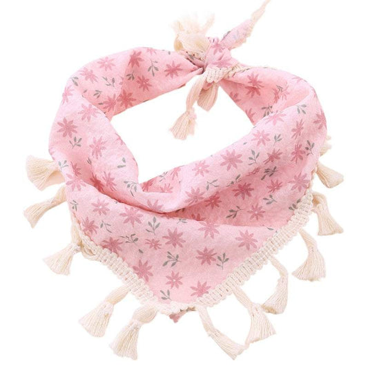 Pink floral pet bandanna with tassels from Pet Panache Boutique, featuring vibrant flower patterns and decorative tassels.