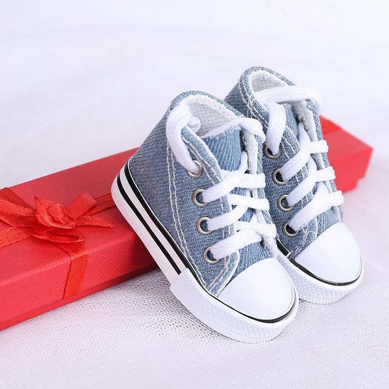 Light blue or yellow canvas pet tennis shoe by Pet Panache Boutique, designed for small dogs, with a comfortable, stylish fit.