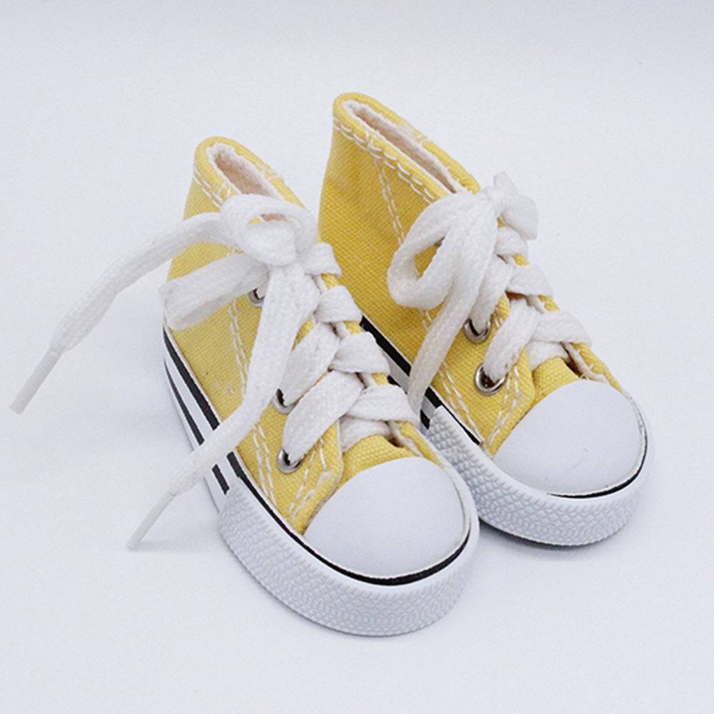 Light blue or yellow canvas pet tennis shoe by Pet Panache Boutique, showcasing comfortable pet footwear with a sporty design.