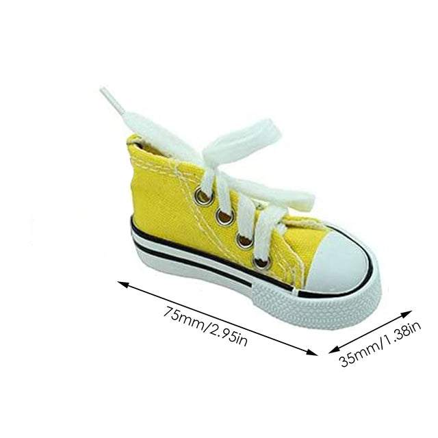 Light blue or yellow canvas pet tennis shoe by Pet Panache Boutique with breathable fabric and flexible sole for small pets.