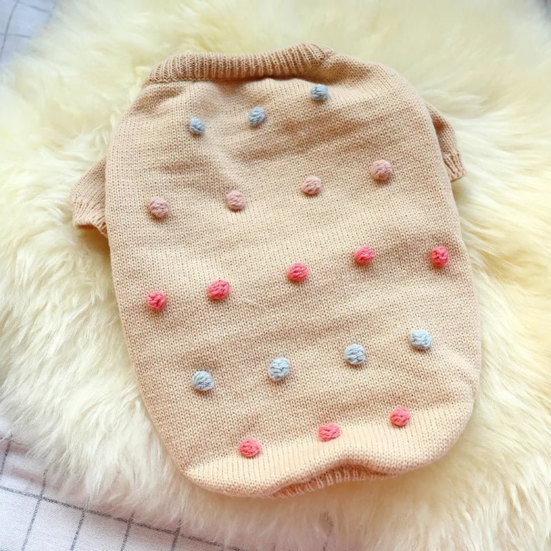 Small dog wearing a cozy Pompom Pet Knit Sweater by Pet Panache Boutique, featuring colorful pompom accents and a snug fit.