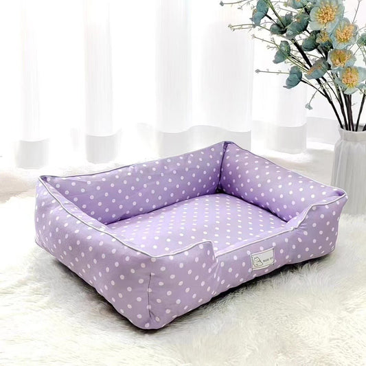 Purple polka dot pet bed from Pet Panache Boutique with soft fabric and cushioned interior for comfort.