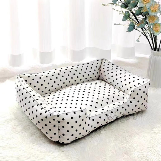White polka dot pet bed by Pet Panache Boutique featuring soft fabric and cozy cushioning for small pets.