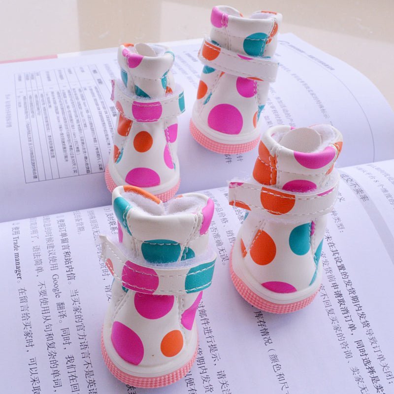 White polka dot pet boots from Pet Panache Boutique, showcasing cozy footwear for small pets with playful polka dot design.